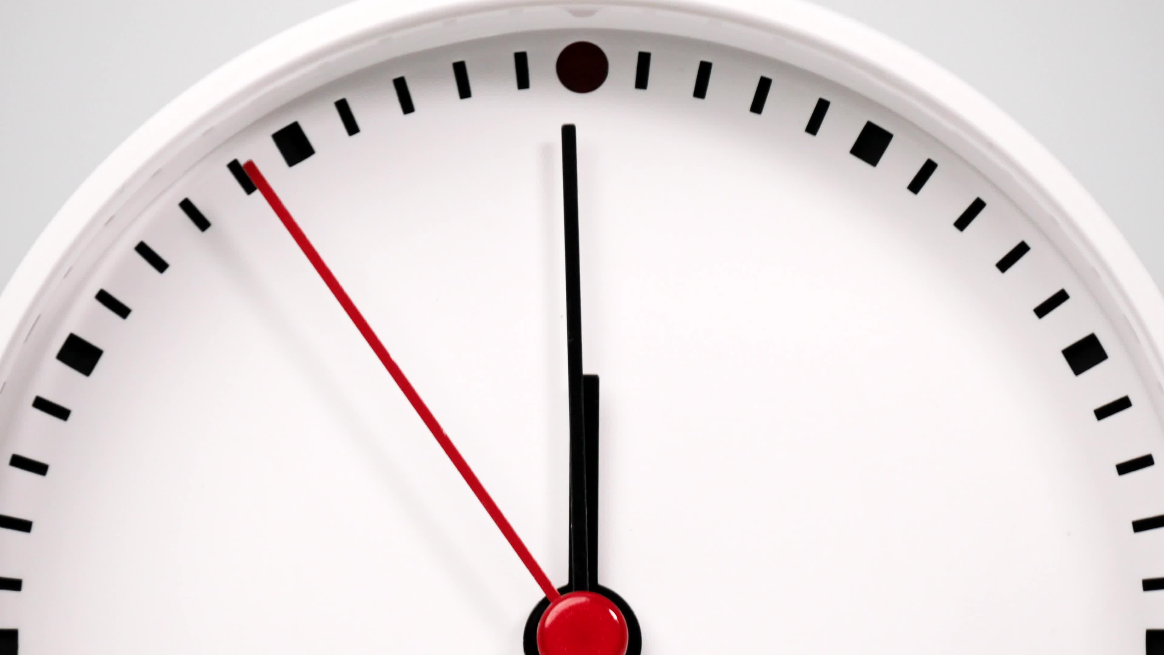Time lapse, White watch with a short hand and a long hand pointing to