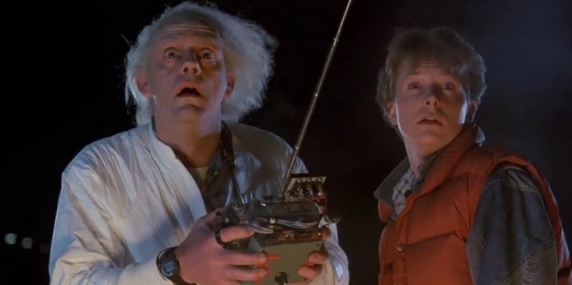 Doc holds a controller next to Marty, both with shocked expressions, in &lsquo;Back to the Future&rsquo;