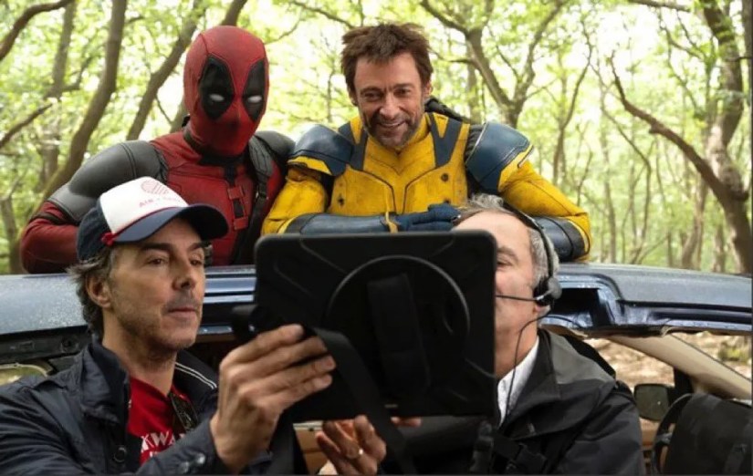 Shaun Levy showing Hugh Jackman and Ryan Reynolds something on an iPad monitor on the set