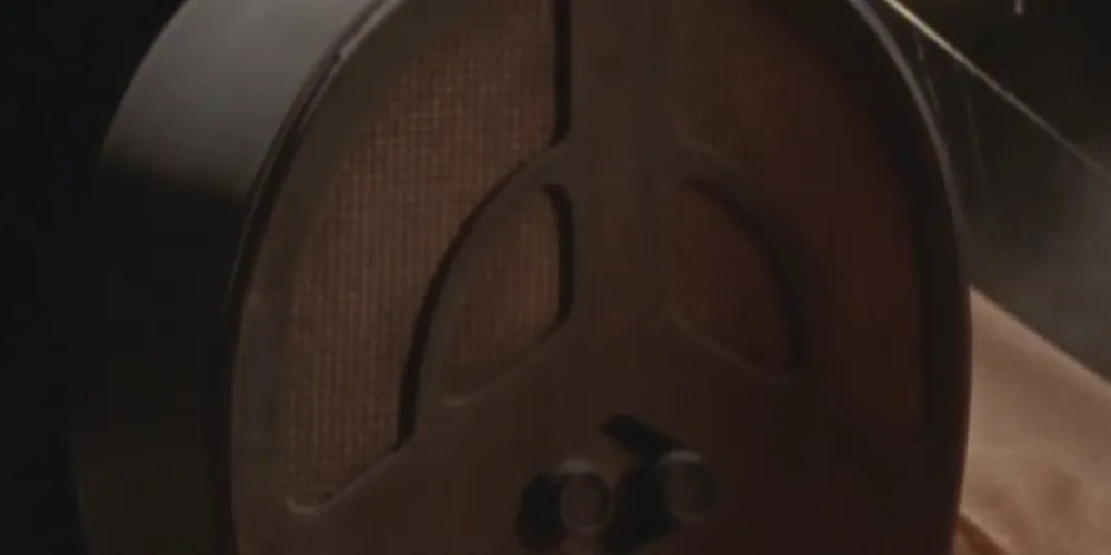 Old-fashioned radio with turn-up dial knobs, and dusty, sepia brown speakers.
