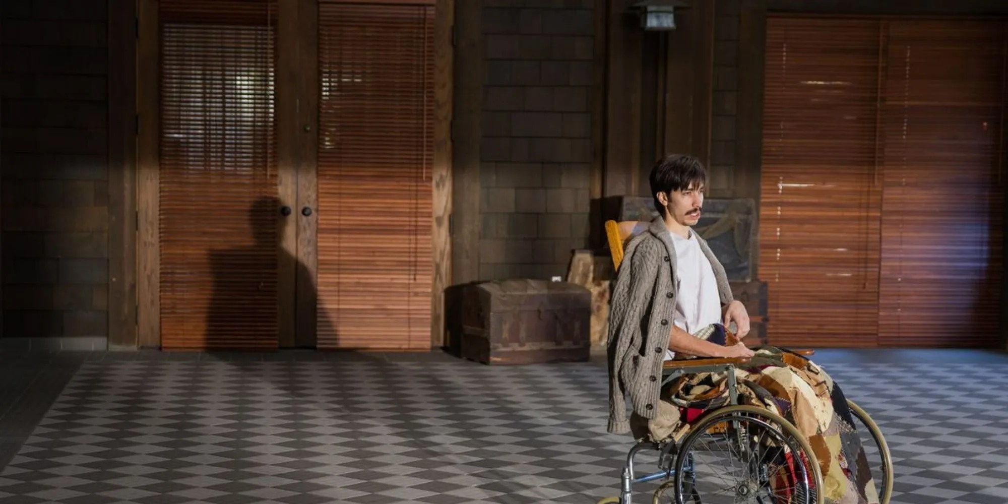 Wallace sits alone in a wheelchair in Tusk