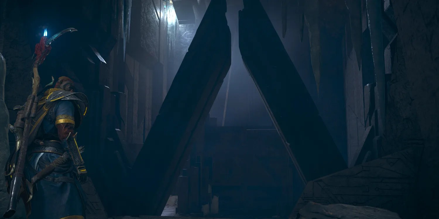 Eivor standing before a triangular archway