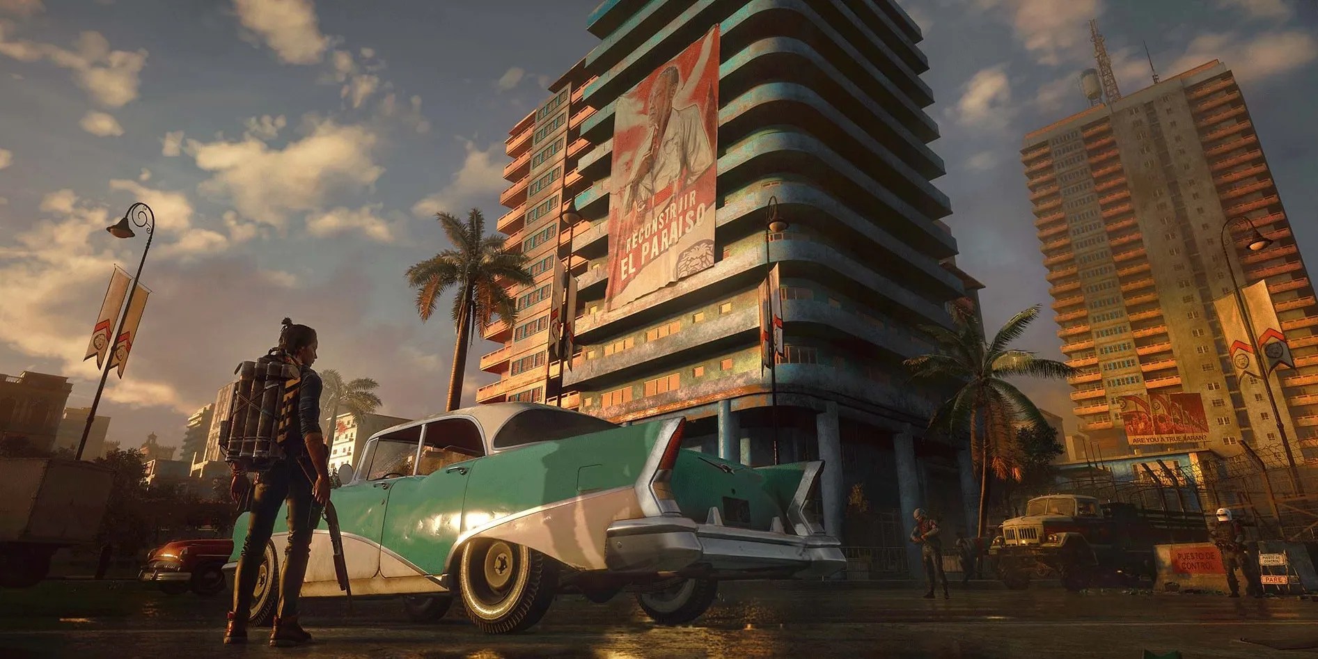 far cry 6 player looking at a car with buildings in the background
