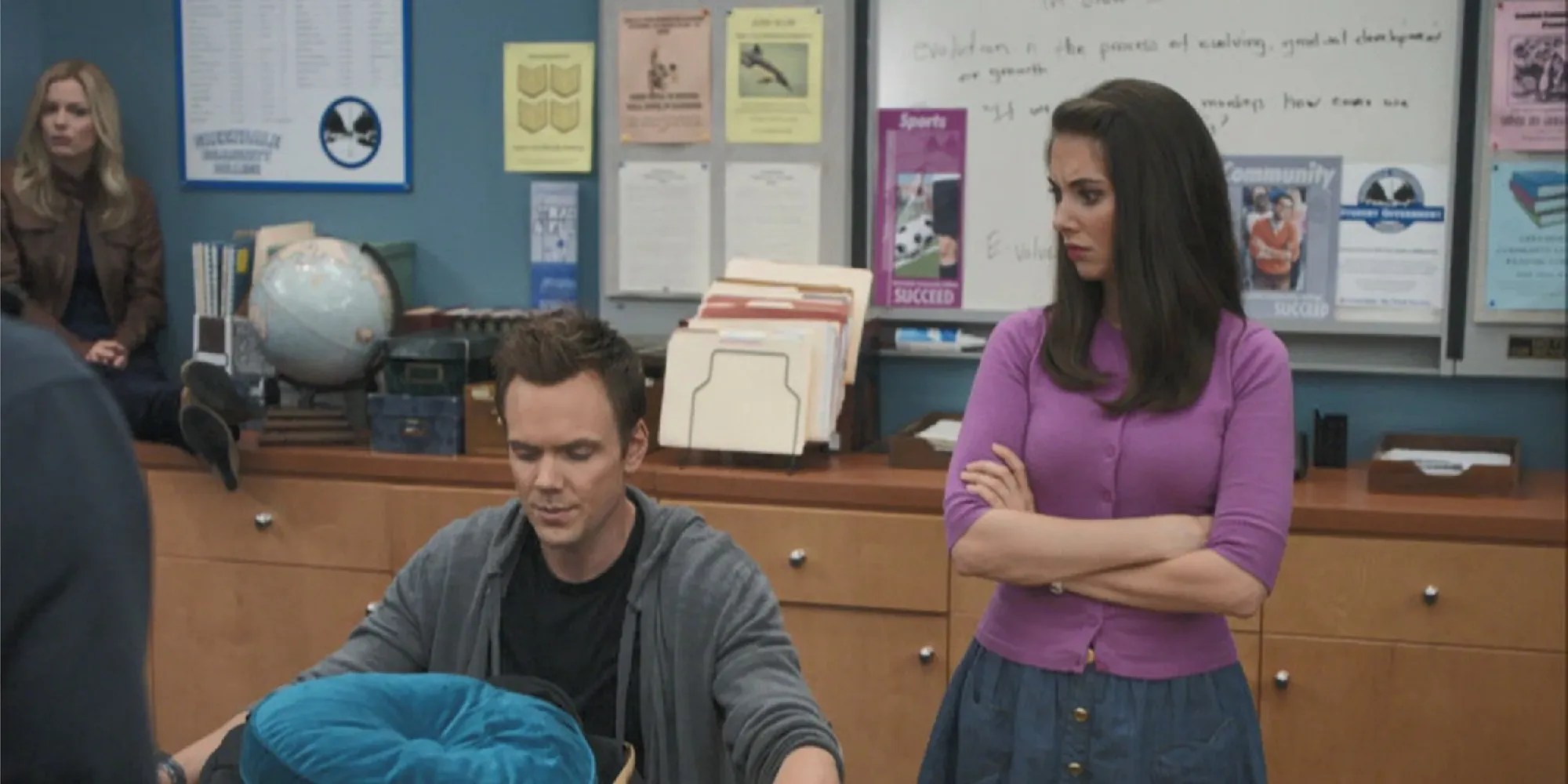 Annie and Britta watching as Jeff inspects Troy&rsquo;s bag in &ldquo;Cooperative Calligraphy&rdquo;