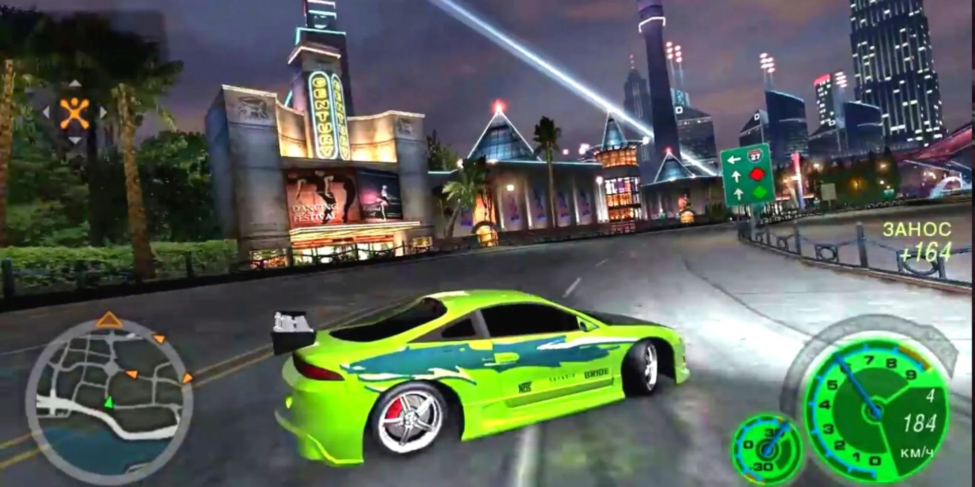 Green sports car racing in city street