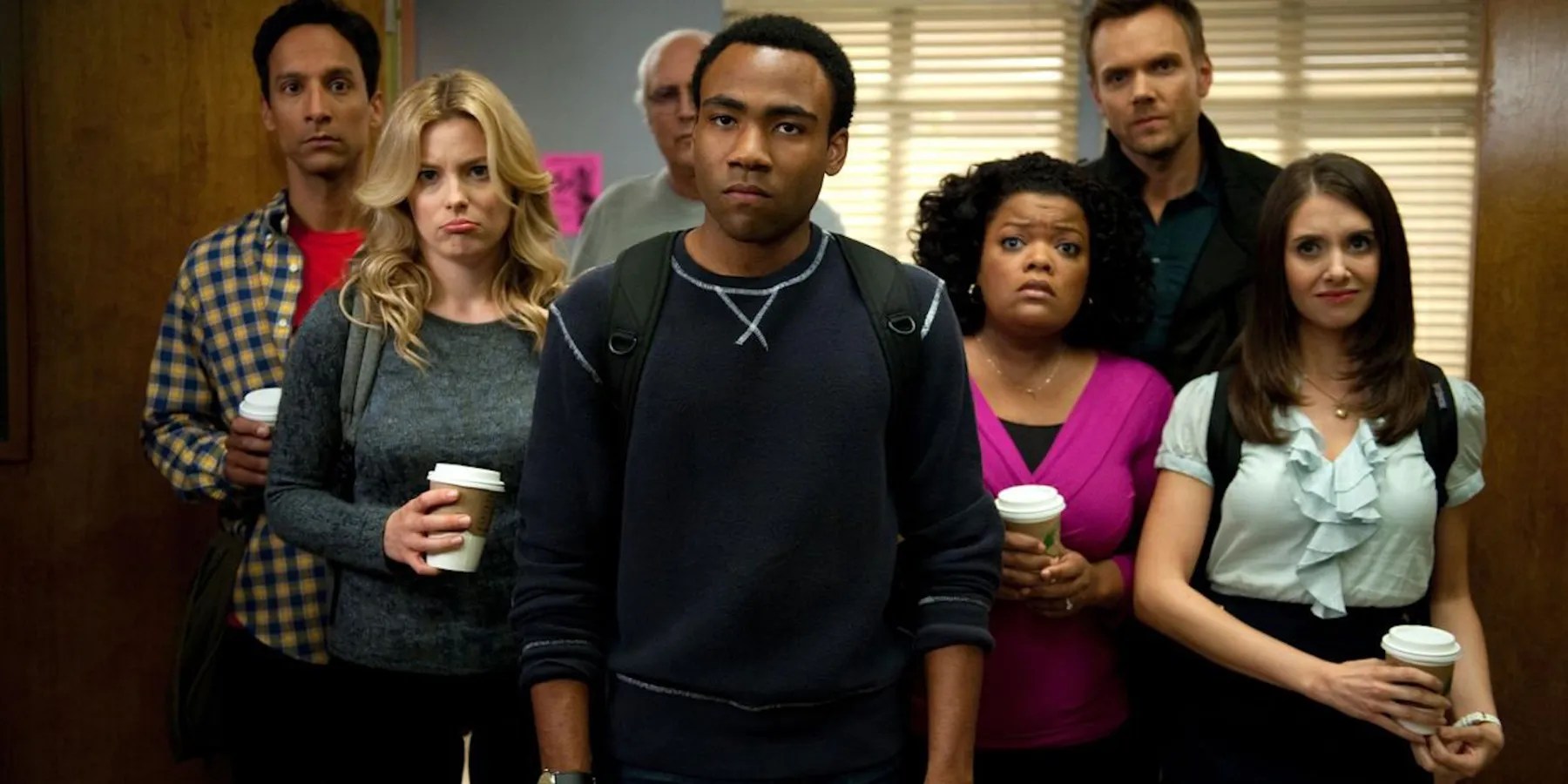 The cast of Community posing together making sad faces
