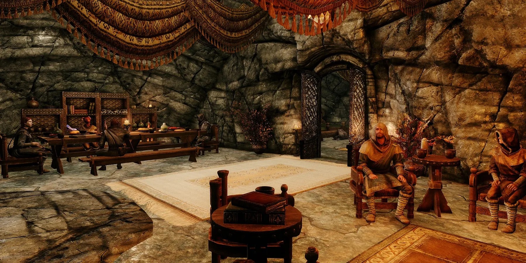 Image from a Skyrim mod showing some mage NPCs hanging out in a tavern.