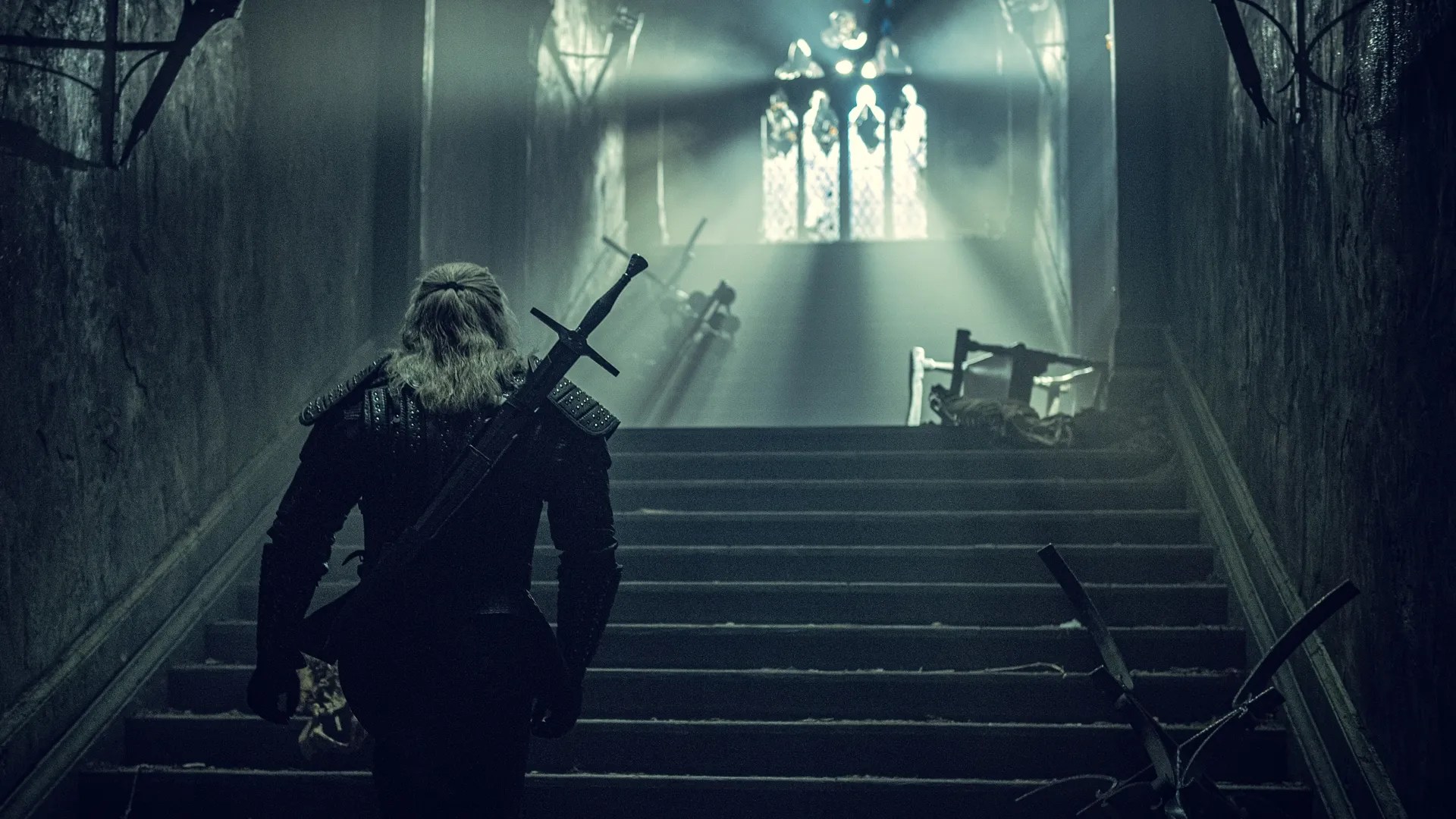 Netflix&rsquo;s The Witcher corridor shot with Geralt of Rivia back turned to camera
