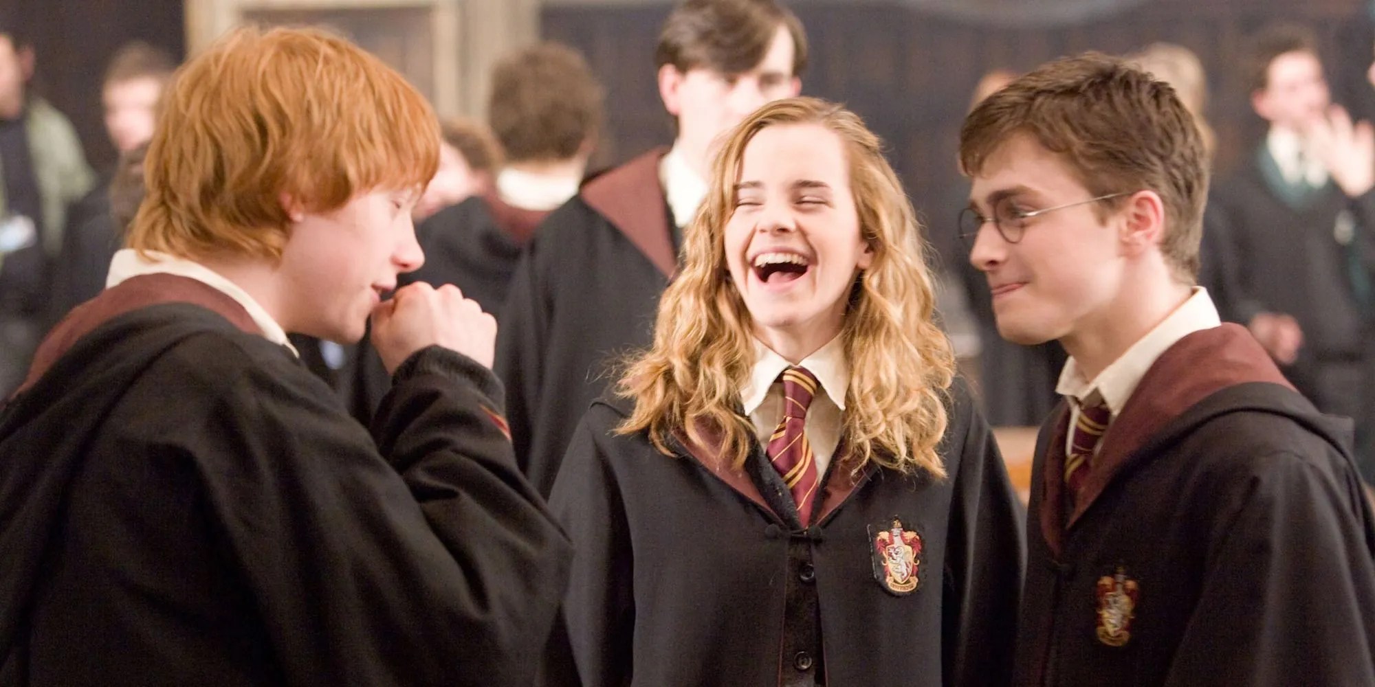 Harry Ron and Hermione laughing in Hogwarts' Great Hall in Harry Potter