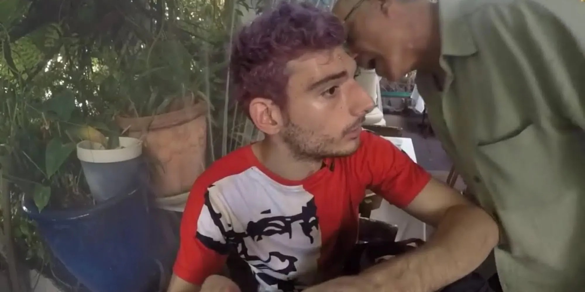 man talking into ice poseidon’s ear