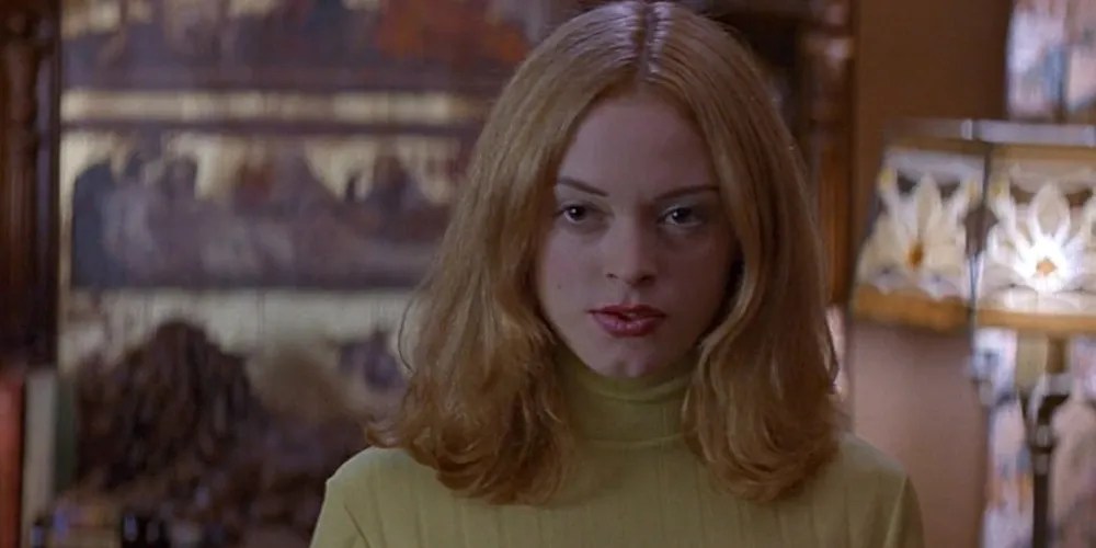 Tatum scowling in a green turtle neck top