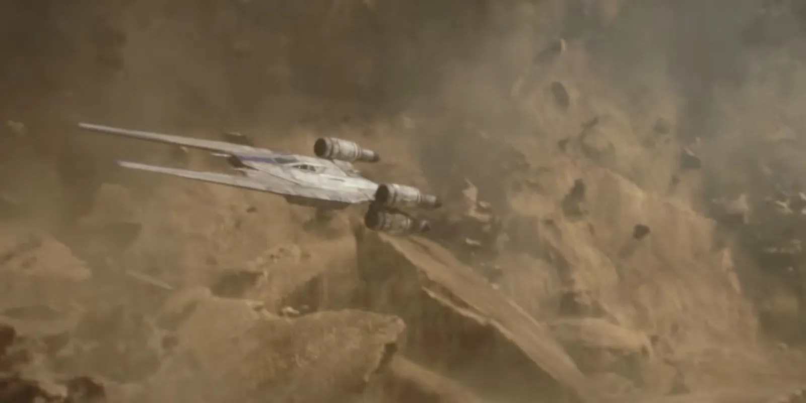 A U Wing escapes from flying rubble in Rogue One: A Star Wars Story.