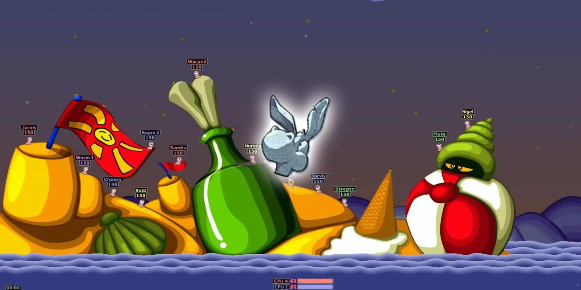 Worms atop of a stage shaped like beach and its items with a glowing stone donkey head in Worms Armageddon