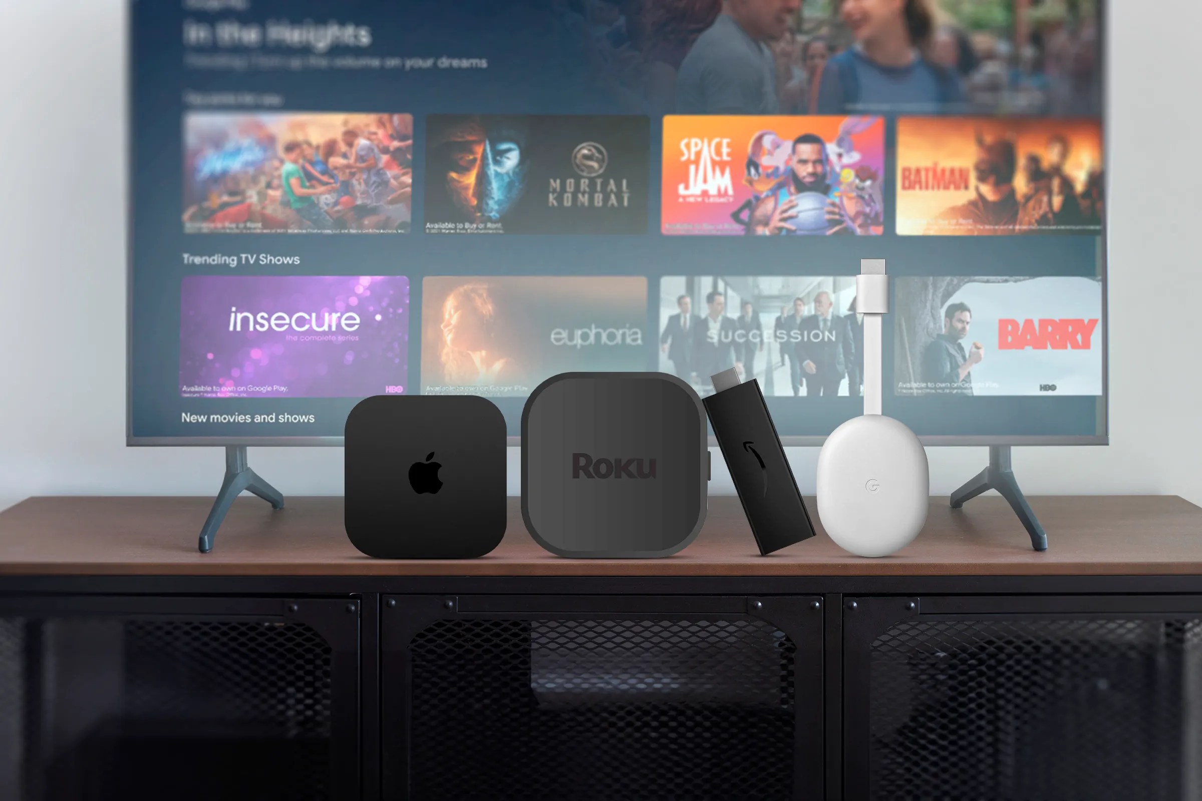 An Android TV with an Apple TV, Roku, Amazon Fire TV, and Chromecast positioned in front.