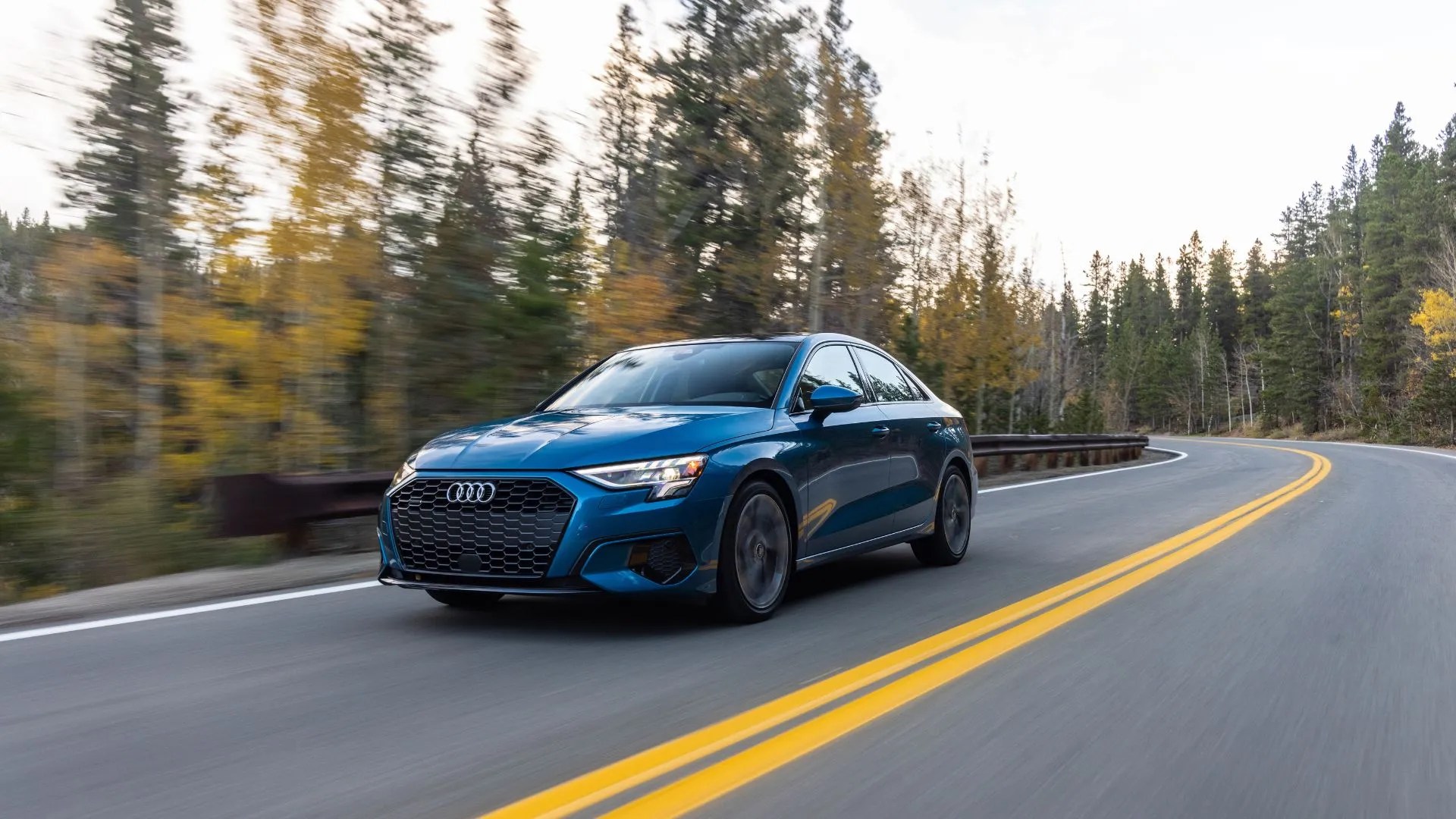 Front 3/4 shot of a 2025 Audi A3 driving on a country road.