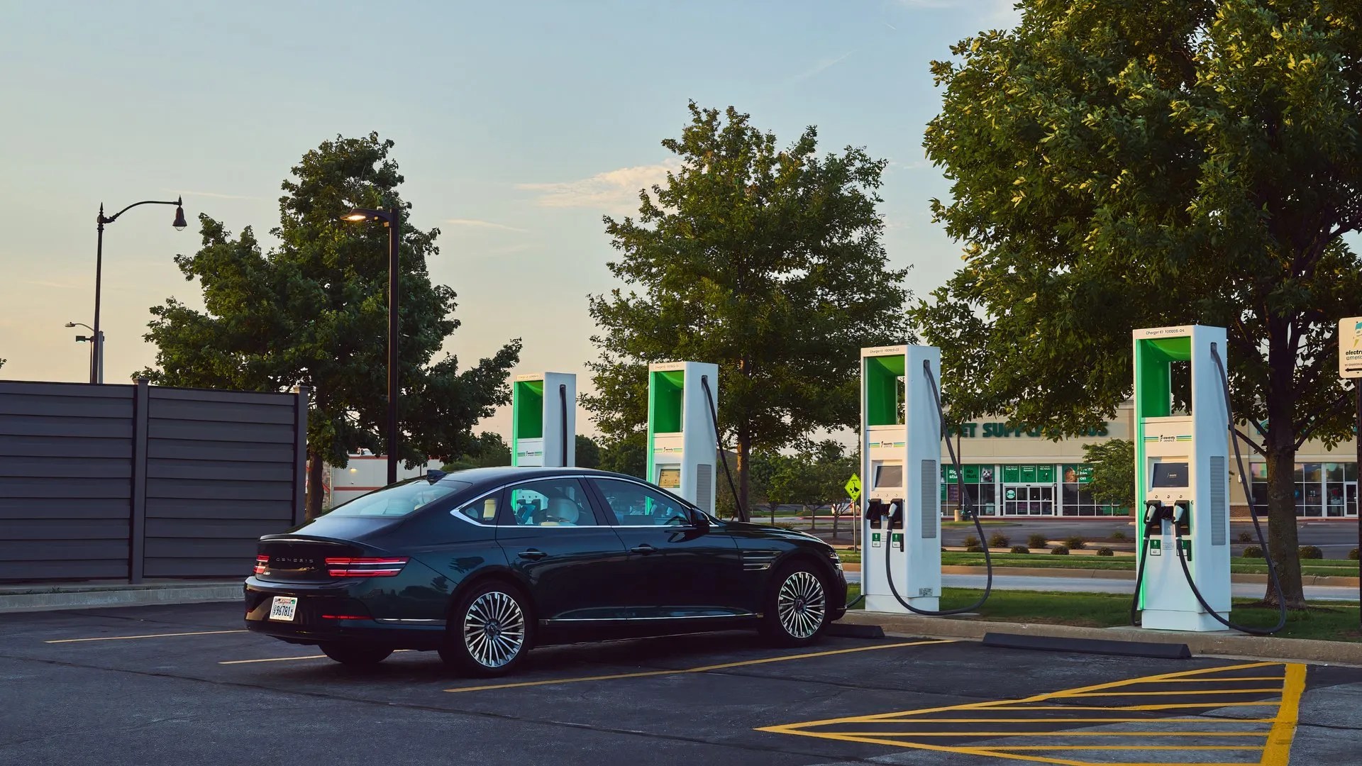 A 2025 genesis electrified g80 parked at a charging station.