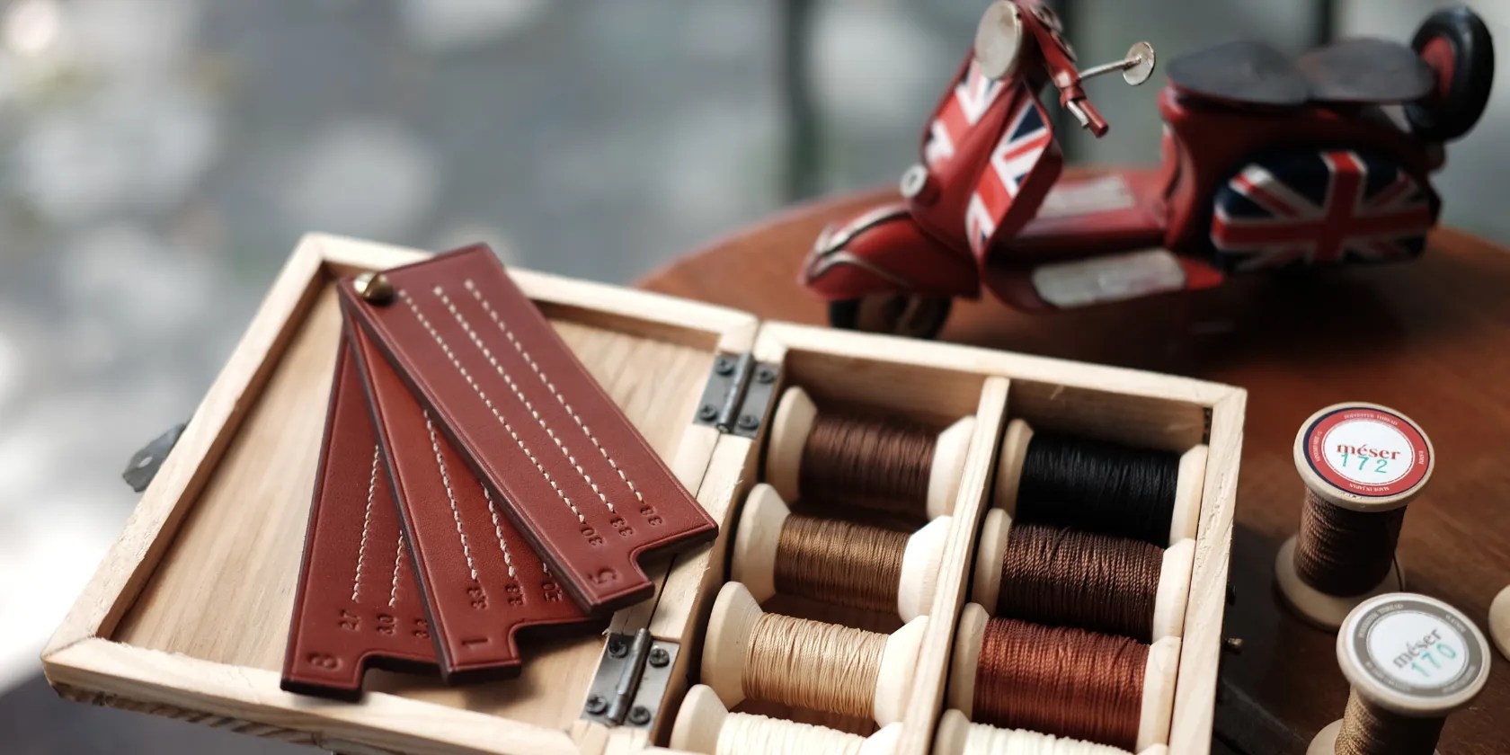 Wooden box with thread and British motorcycle