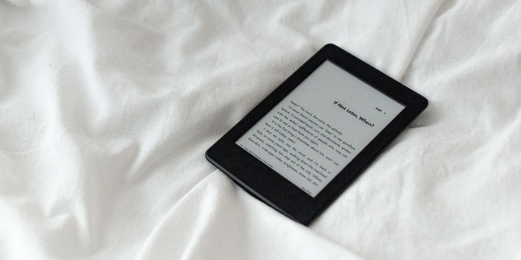 An e-reader on a bed.