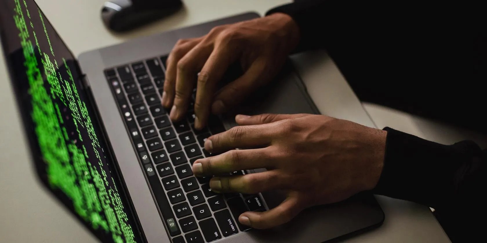 Photo of an open laptop with code on the screen.