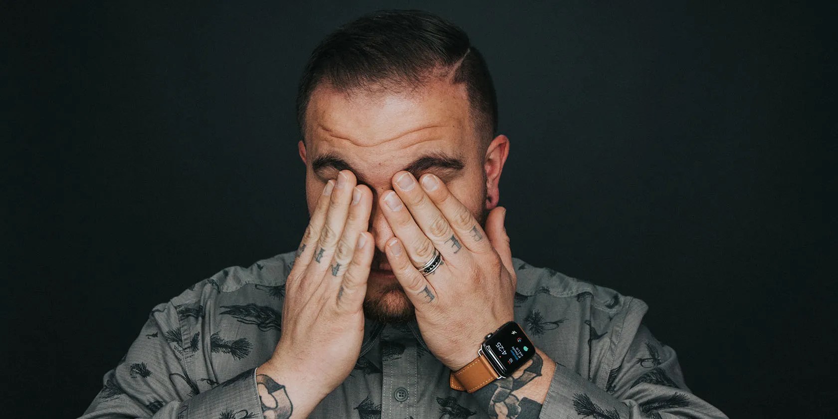 Man Rubbing Eyes with Hands