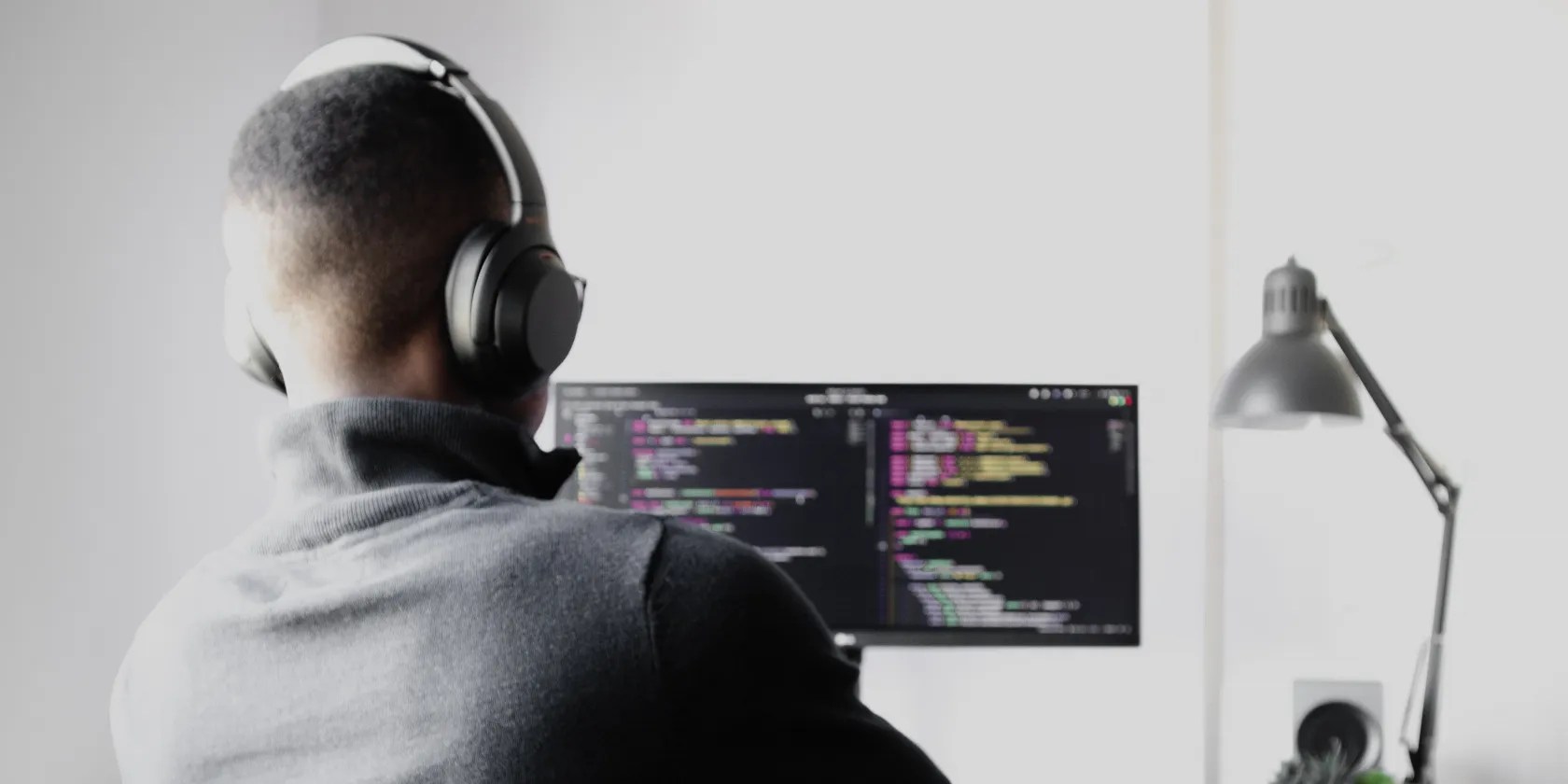 Photo of a programmer sitting at a computer