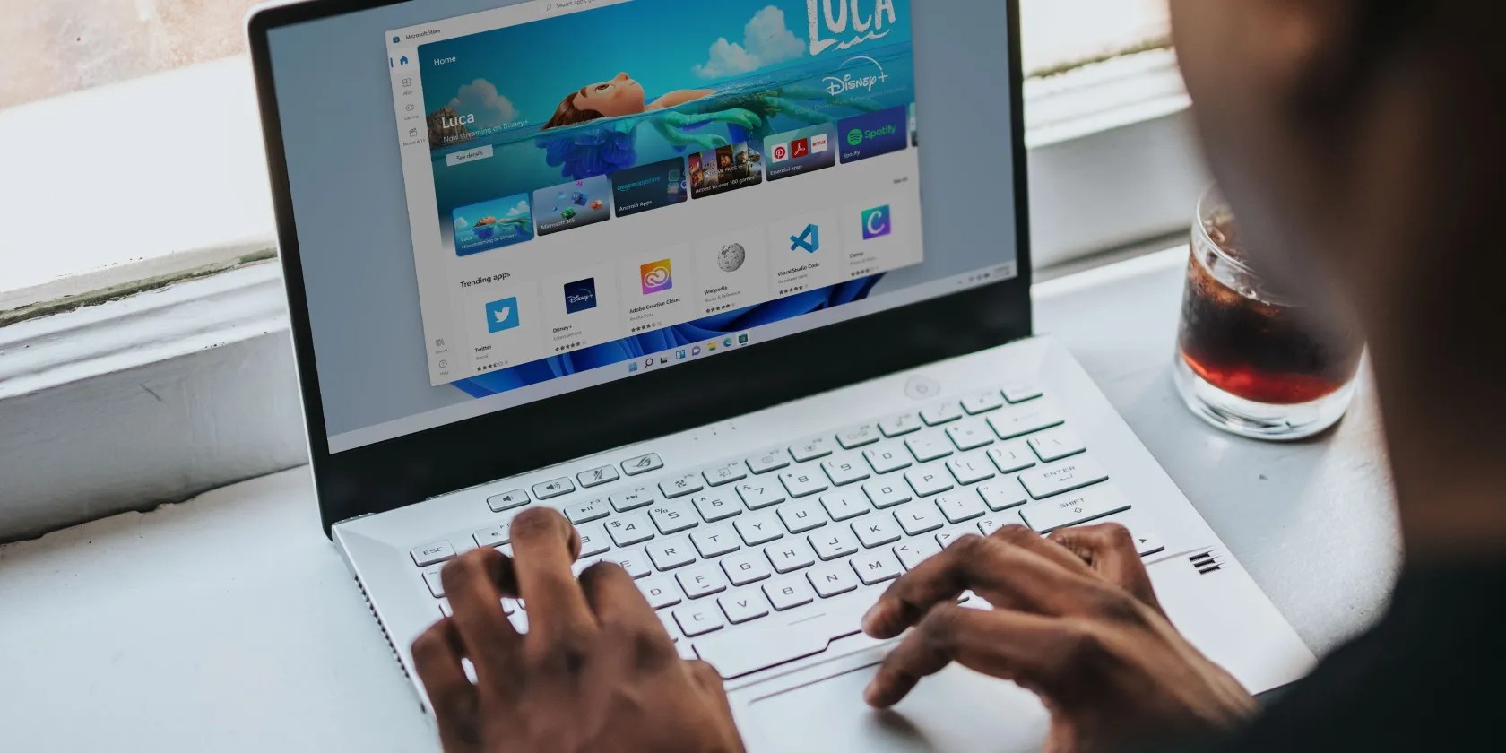 Man browsing the Windows 11 Microsoft store on a laptop