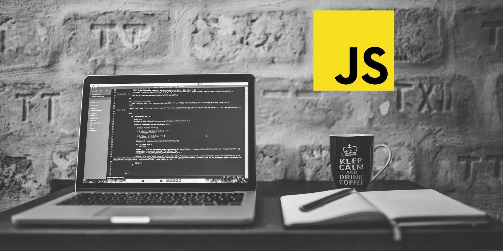 Laptop, coffee mug, and JavaScript logo