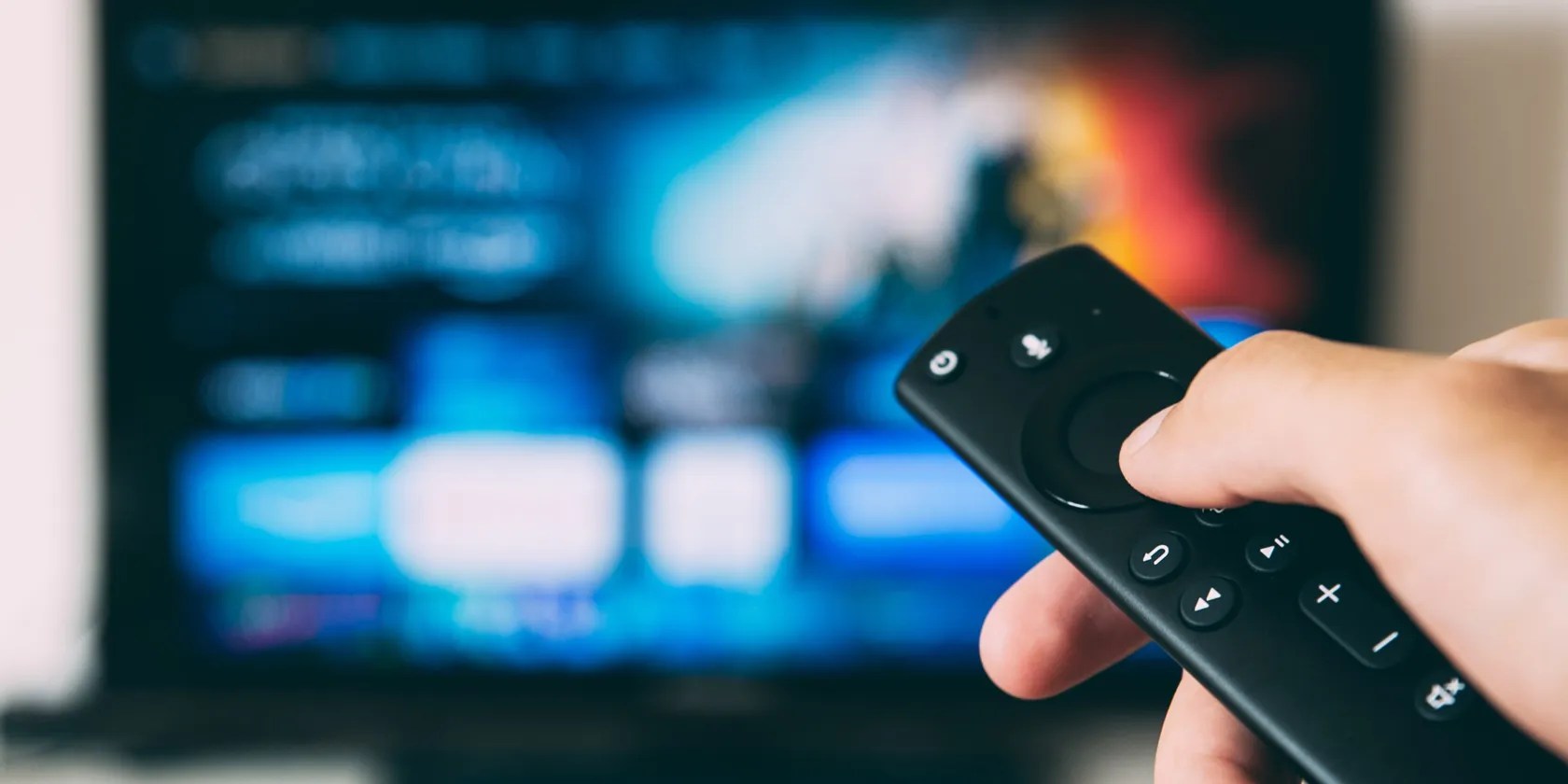 Hand with remote control watching streaming video