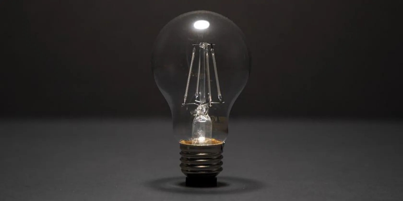 A light bulb on.a dark background