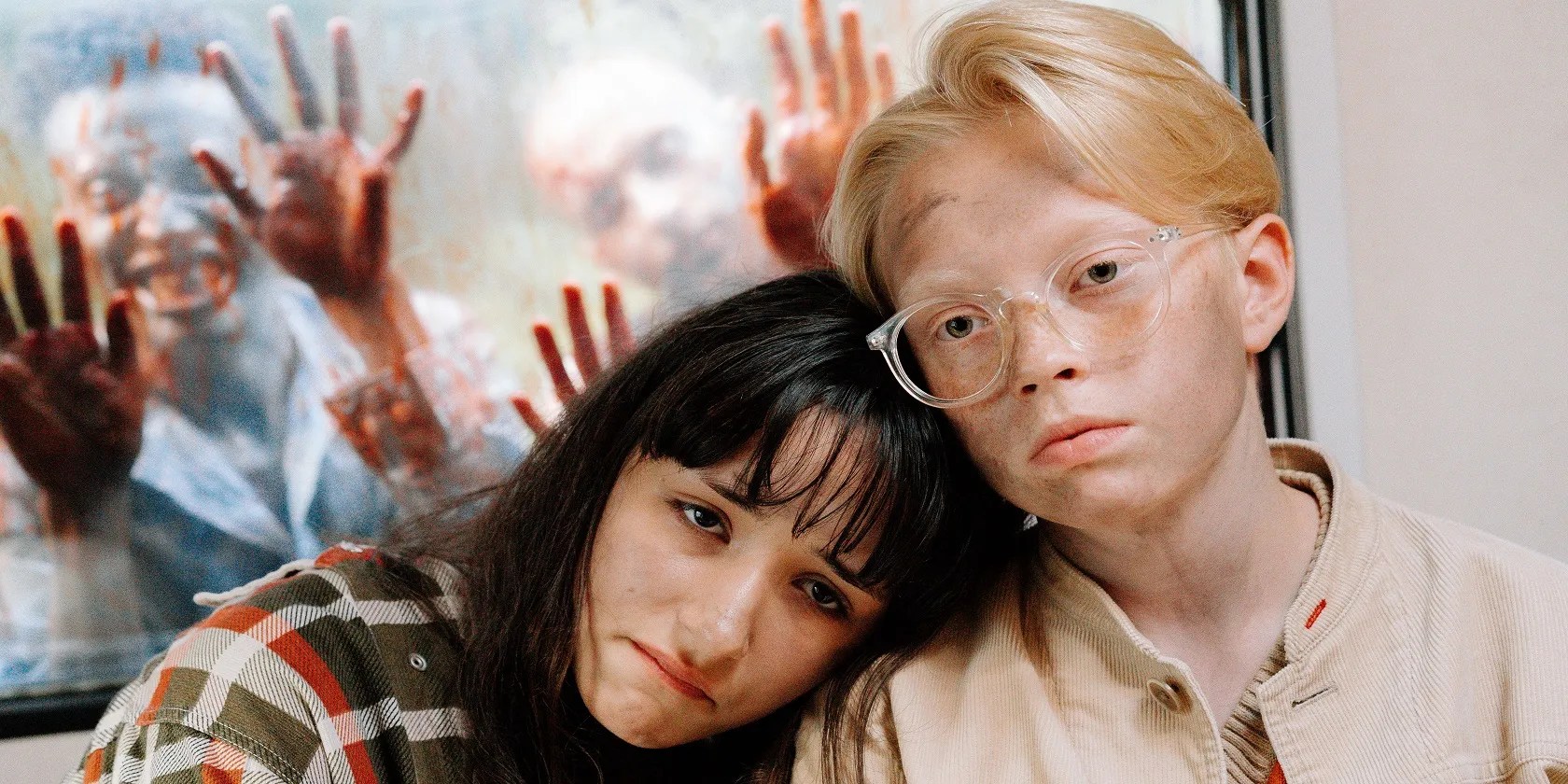 A girl and a boy hiding from two zombies