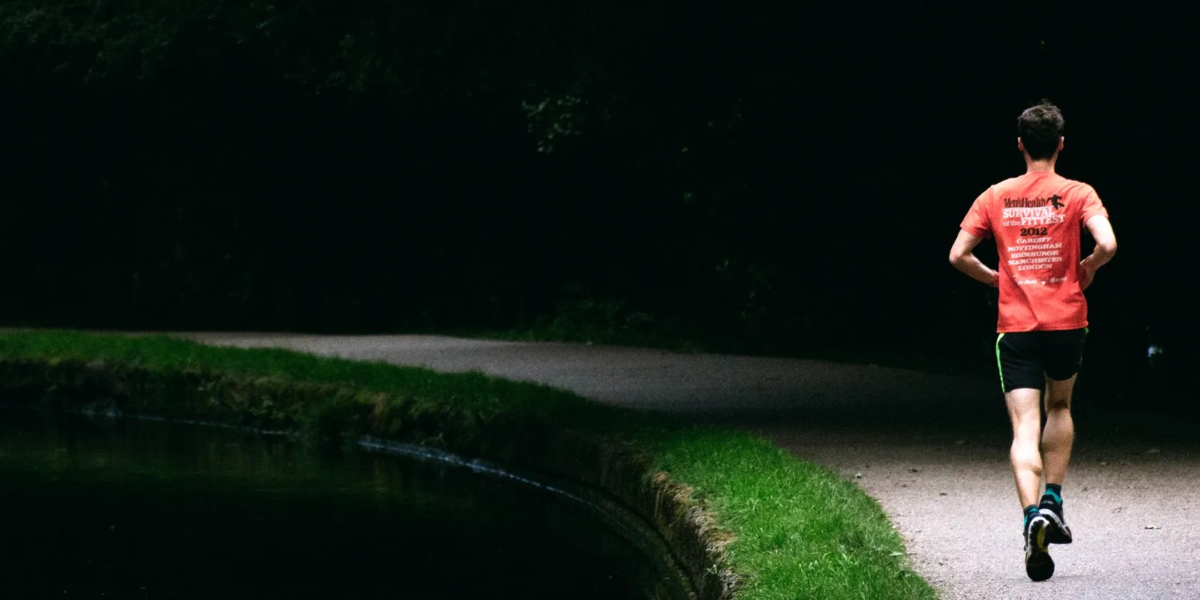 man running with trees in background
