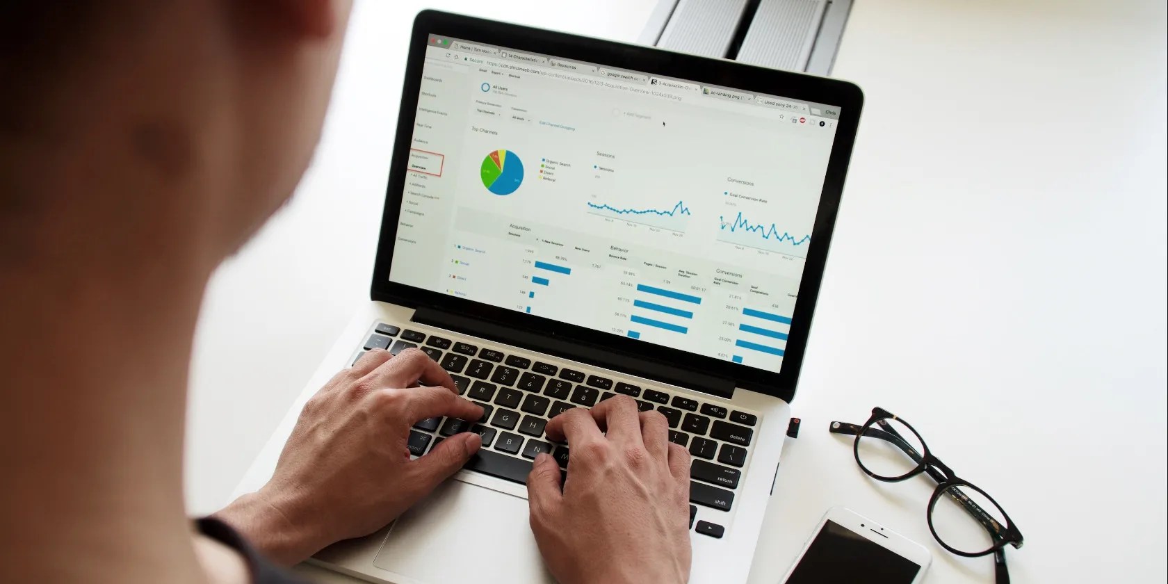 Person working on spreadsheets on laptop