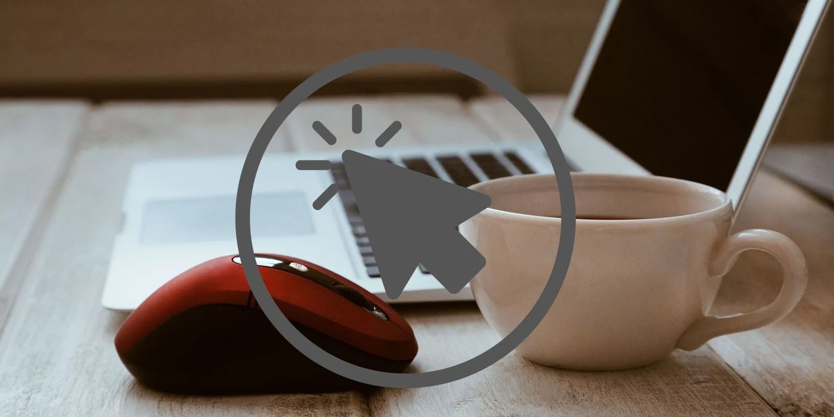 Mouse Placed on a Table With Pointer Icon Along With Cup and Laptop