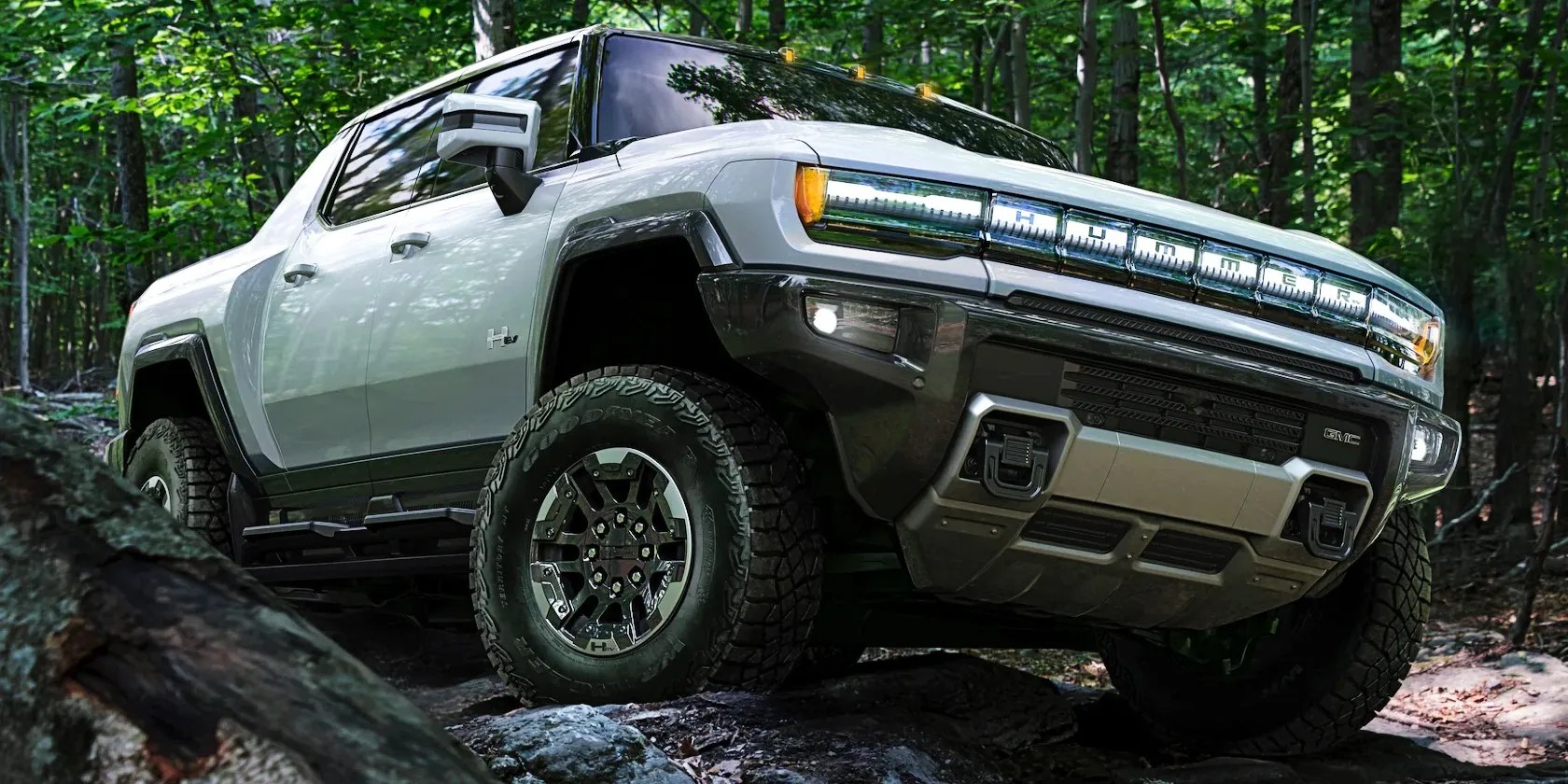 A Hummer EV in extract mode moving through rocks