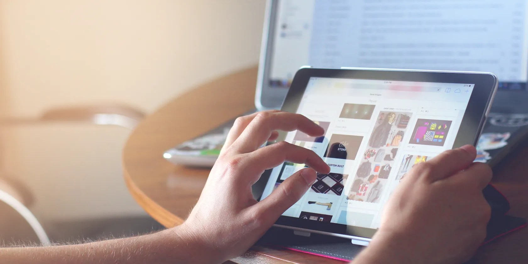 Person Using iPad in front of laptop featured image