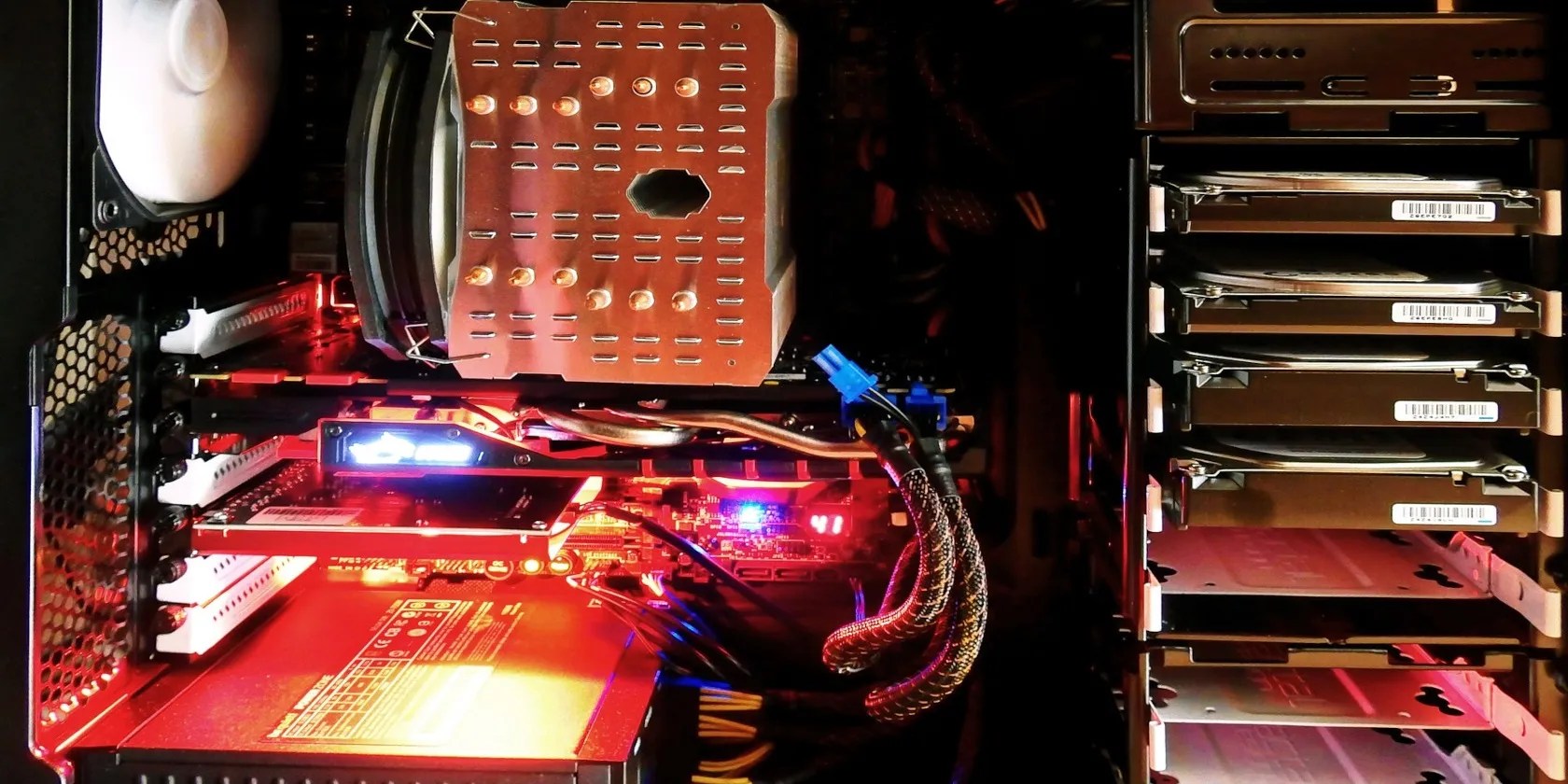 The inside of a desktop tower computer case prominently showing several hard drives