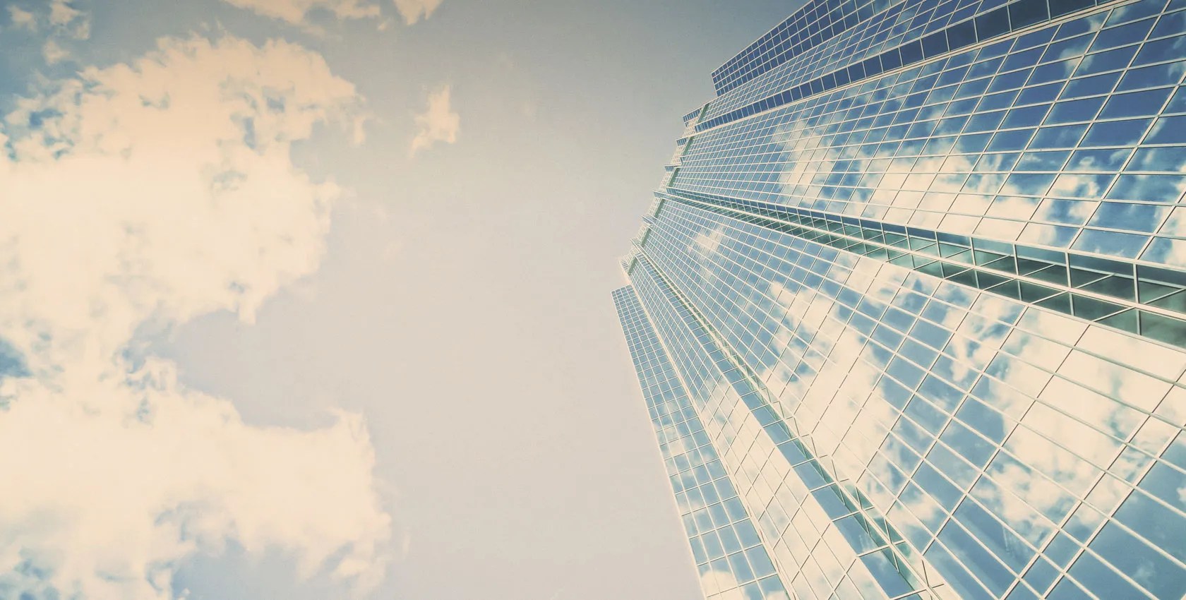 View of a skyscraper and clouds from the ground