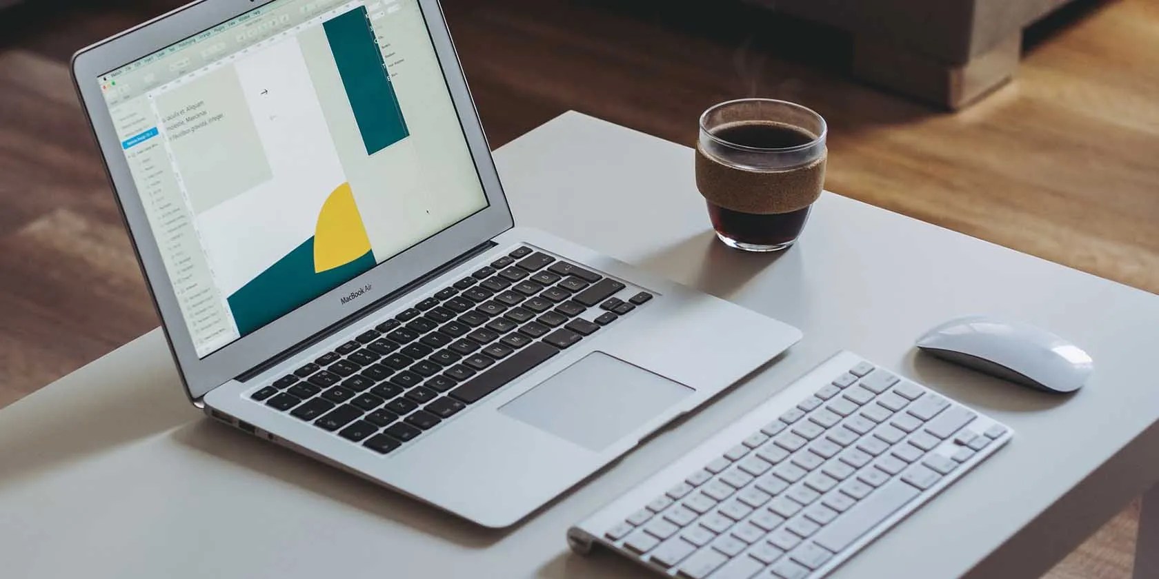 MacBook on a desk with a mouse and keyboard