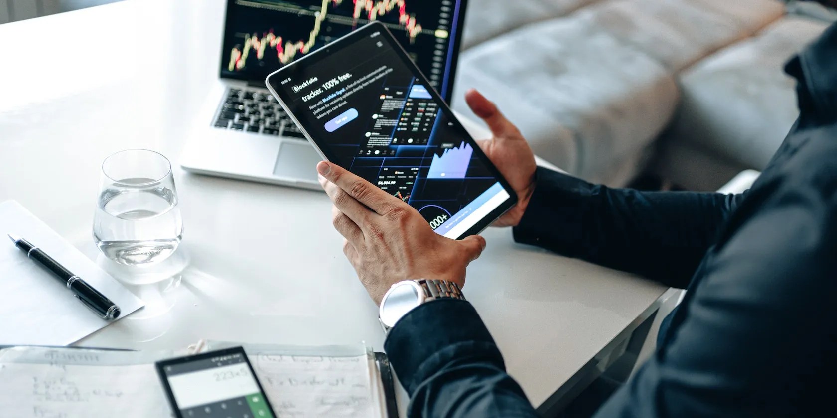 A Person Holding Digital Tablet With Graphs