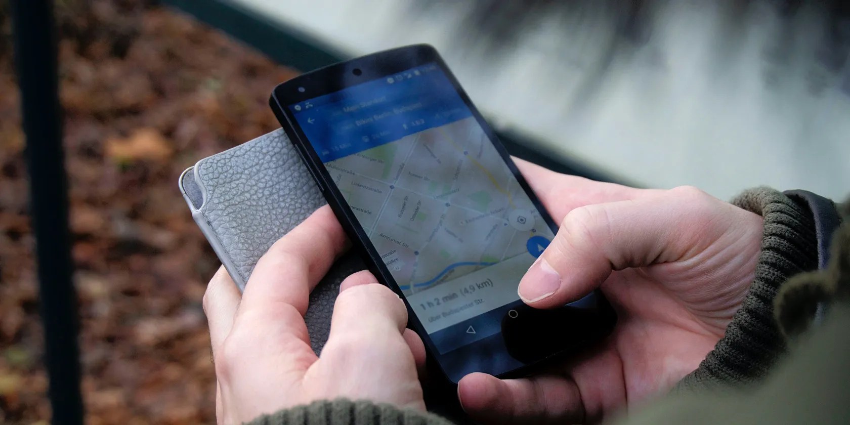 Person holding phone and using Google Maps