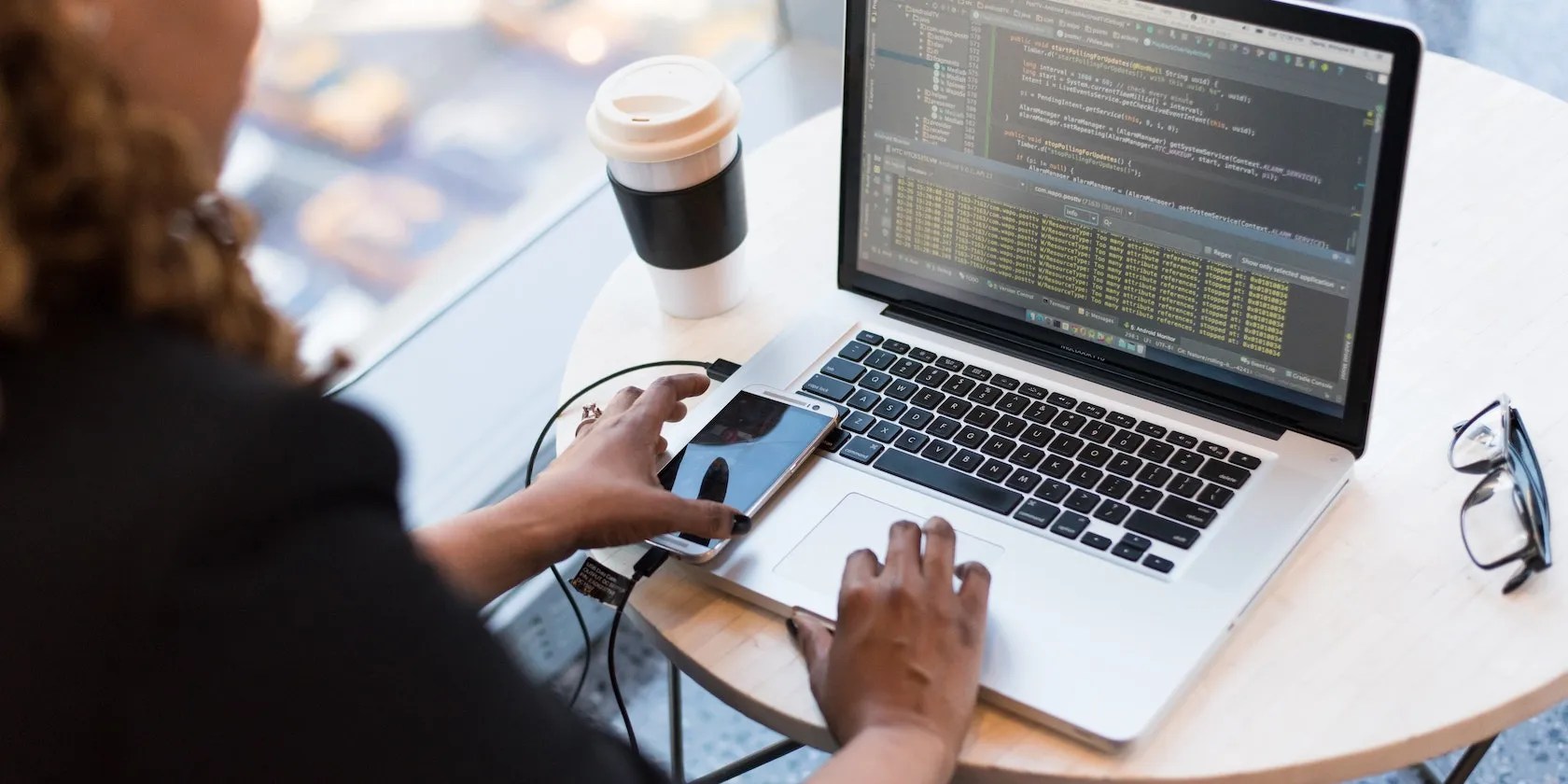 Person coding with silver laptop