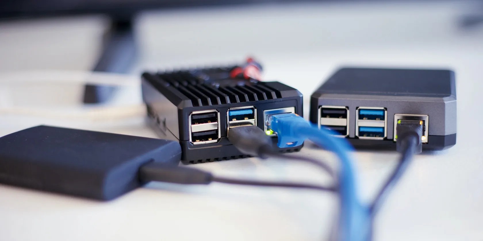 Two Raspberry Pi boards in cases with cables