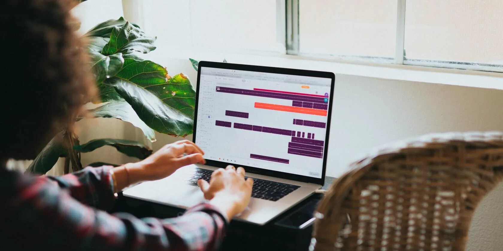 Woman using a calendar app for managing time on her laptop