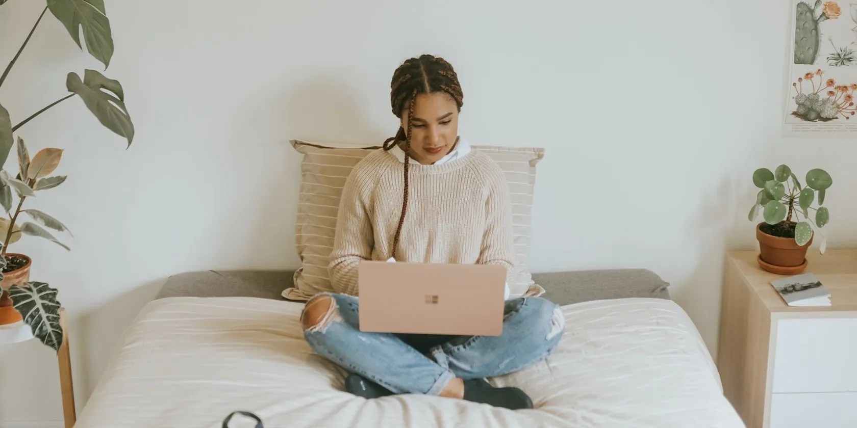 A lady using a Windows PC while sitting on bed