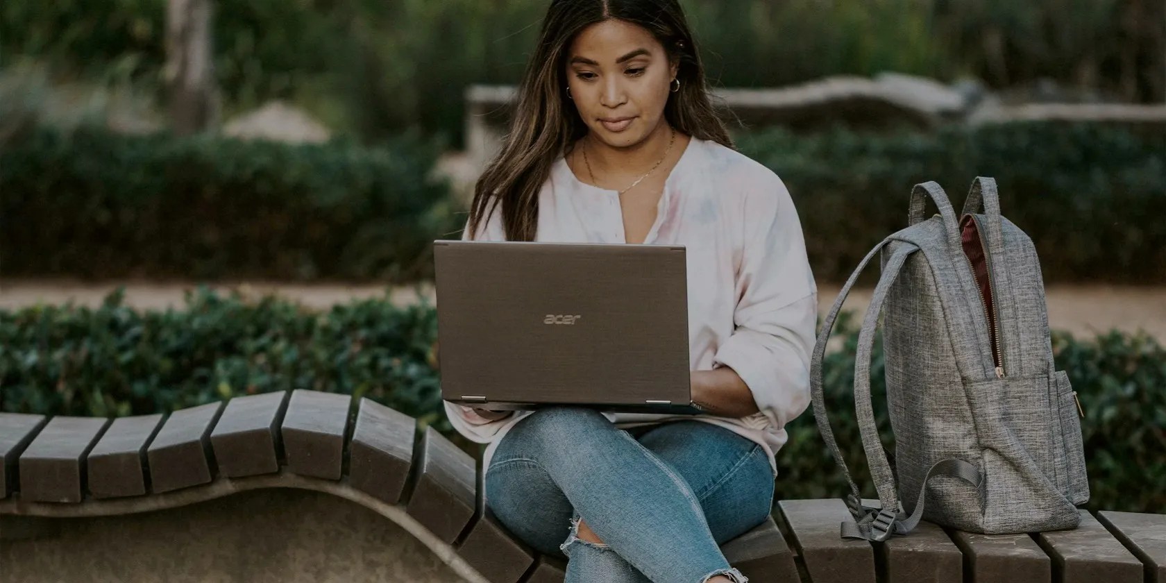 A lady using a Windows PC while sitting outside
