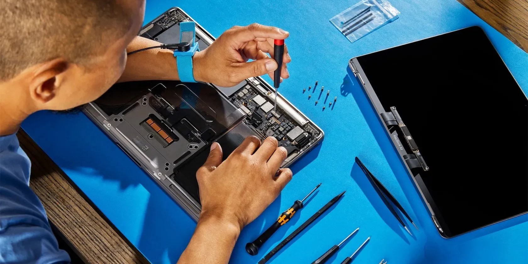 technician repairing a MacBook