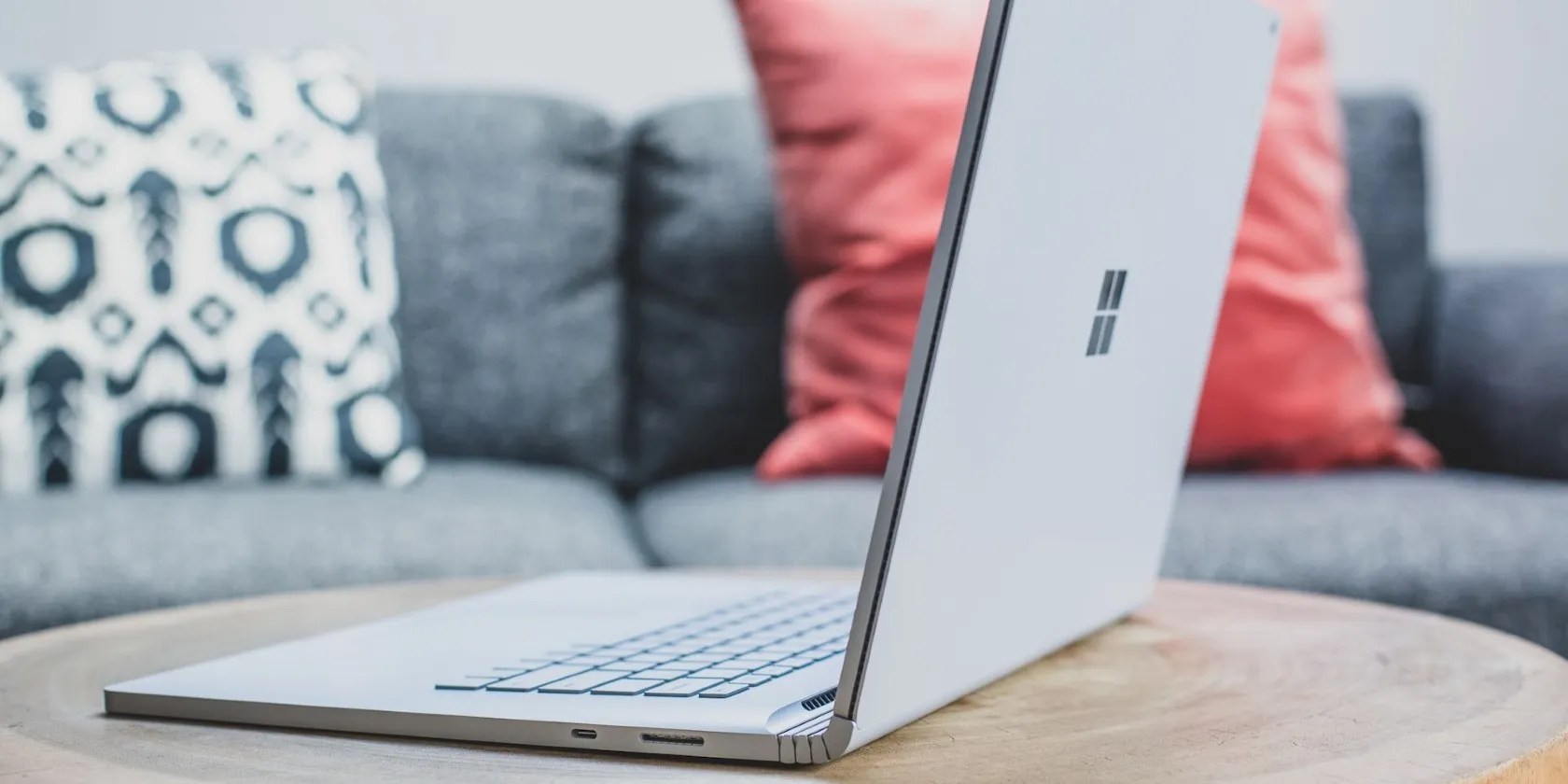 A gray Windows laptop on a wooden table