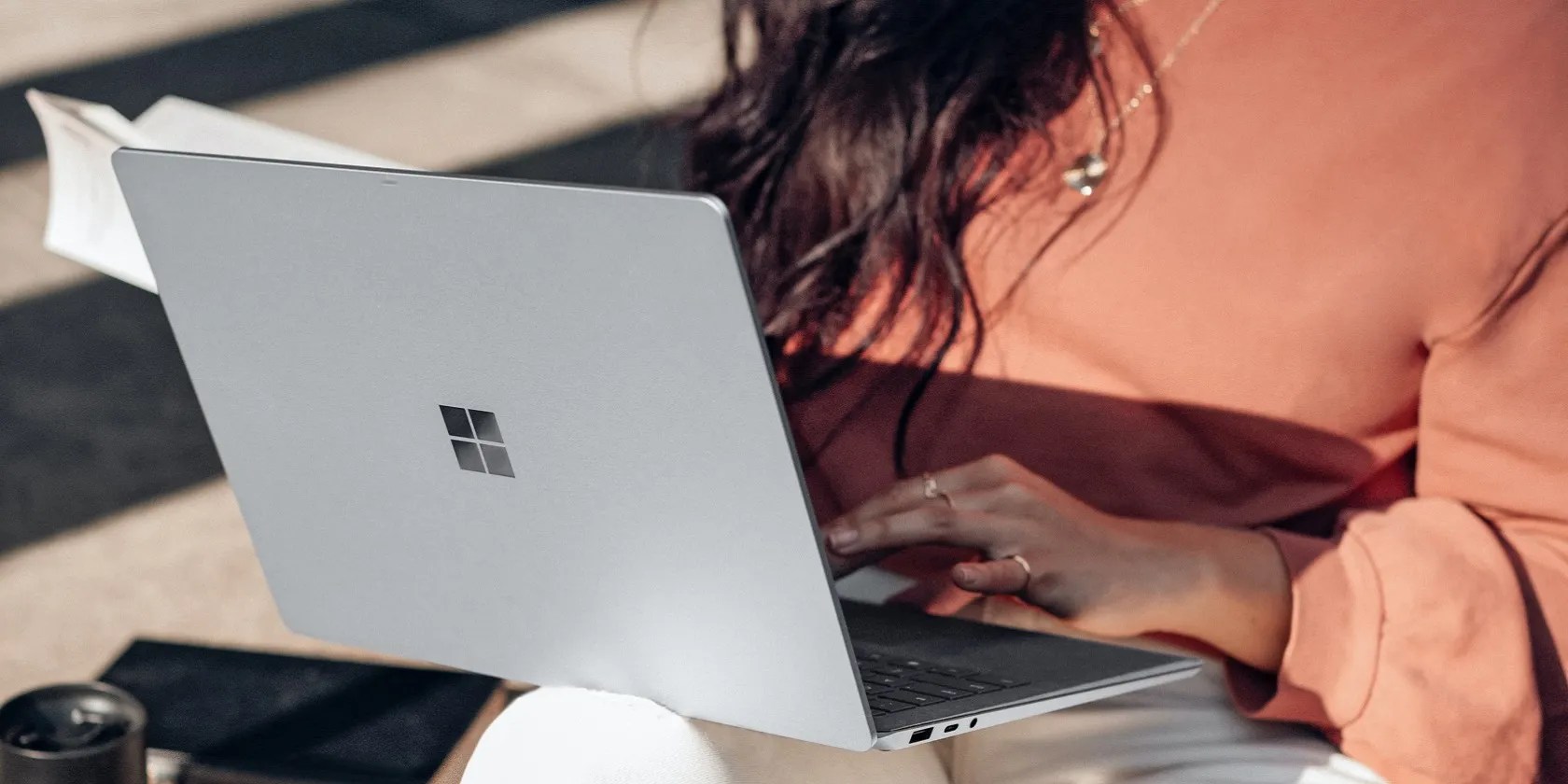 Person using a Windows device while placing it on a lap