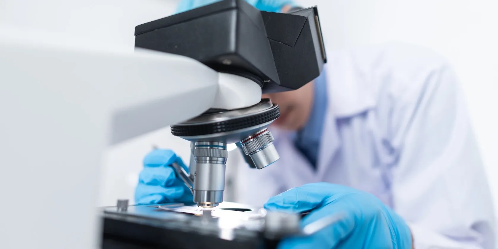 A scientist Using Microscope