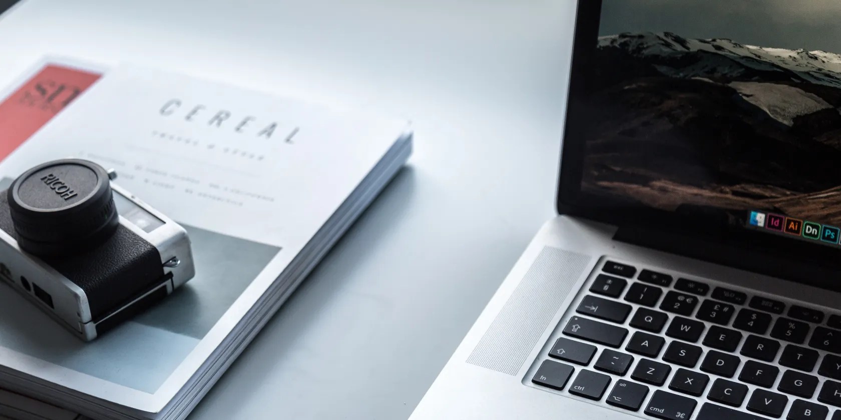 photo of a camera next to a computer